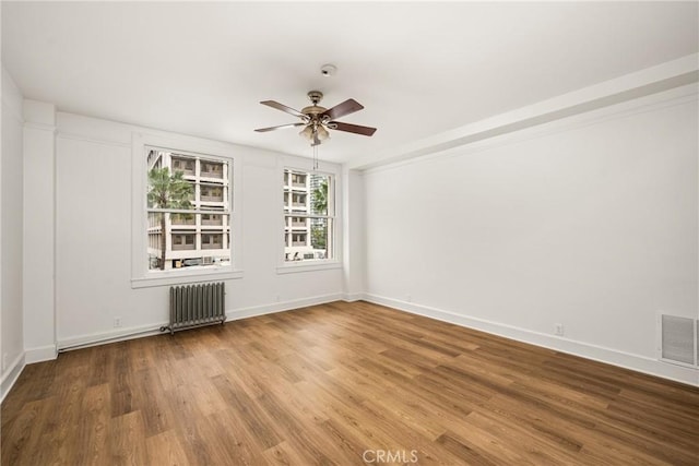 455 E Ocean Blvd Unit 411, Long Beach, CA 90802 - unfurnished room with radiator, ceiling fan, wood finished floors, and baseboards