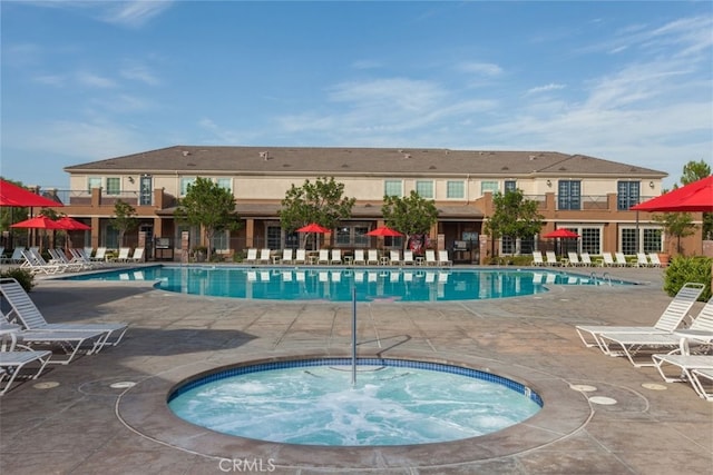 community pool with a community hot tub and a patio