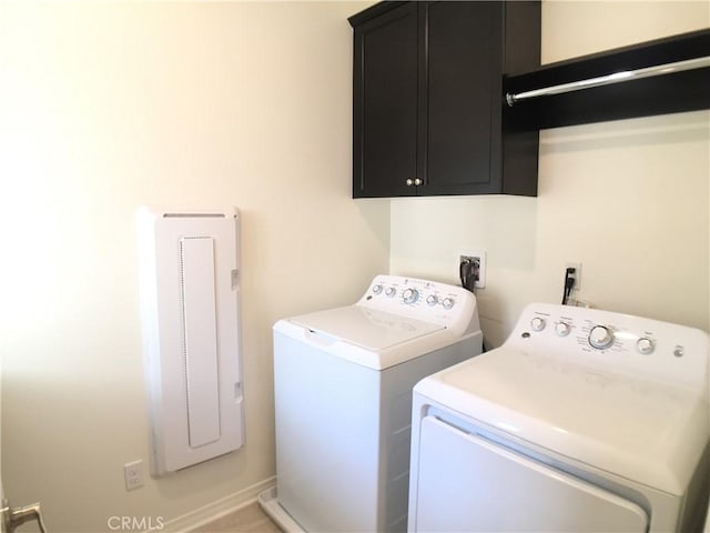 laundry area featuring washing machine and clothes dryer and cabinet space
