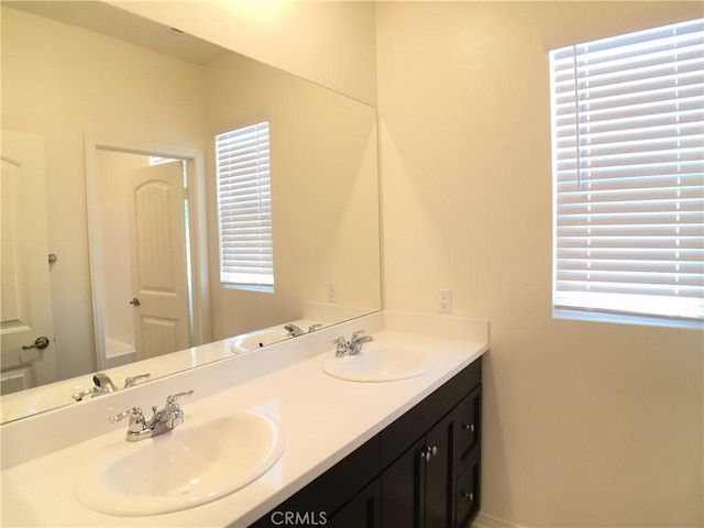 bathroom featuring double vanity and a sink