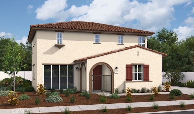 mediterranean / spanish-style house featuring a tile roof, stucco siding, and fence