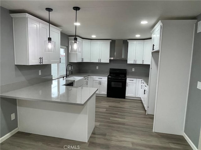 13749 Dahl Way, Moreno Valley, CA 92553 - kitchen featuring gas stove, recessed lighting, a peninsula, a sink, and wall chimney exhaust hood