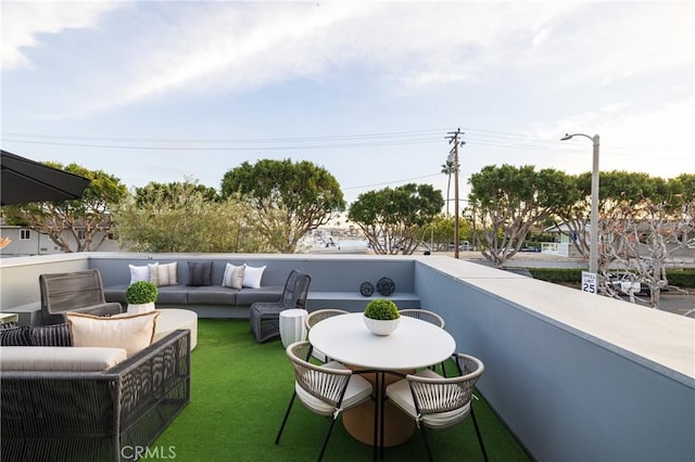 view of patio featuring an outdoor hangout area and a balcony