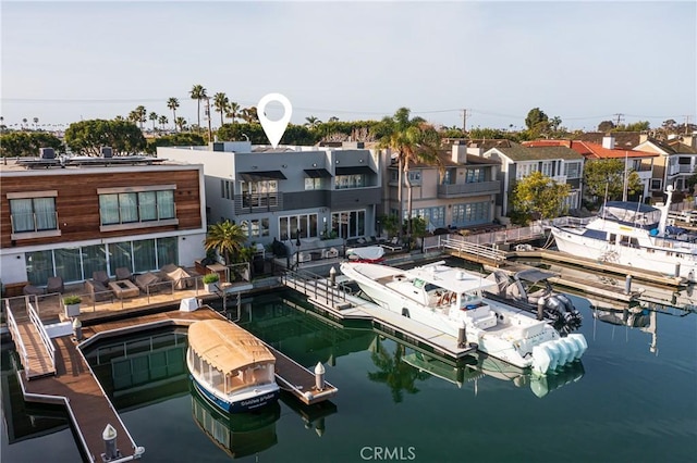 view of dock featuring a residential view and a water view