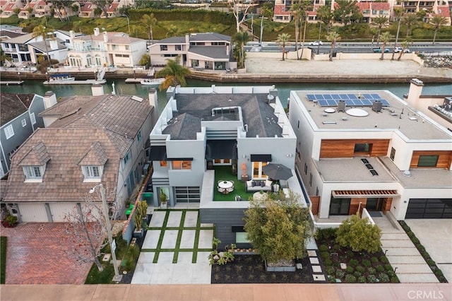 drone / aerial view with a residential view and a water view