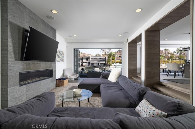 living area featuring a fireplace and recessed lighting