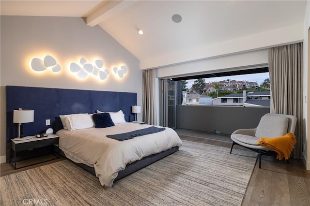 bedroom featuring lofted ceiling with beams and wood finished floors