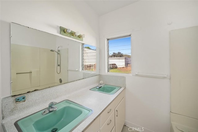 full bath featuring a sink and double vanity