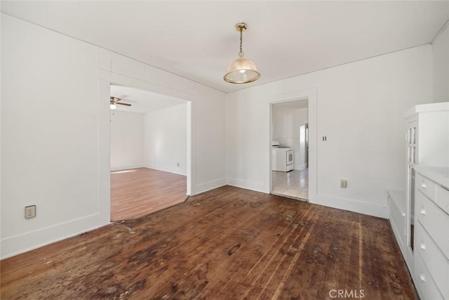unfurnished dining area with wood-type flooring, a ceiling fan, and baseboards