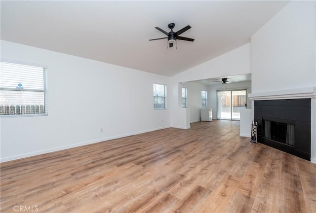 13625 Brynwood St, Victorville, CA 92392 - unfurnished living room featuring ceiling fan, a fireplace, vaulted ceiling, light wood-style floors, and baseboards