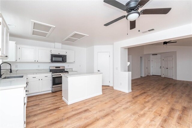 13625 Brynwood St, Victorville, CA 92392 - kitchen featuring stainless steel gas range, black microwave, a sink, open floor plan, and light countertops