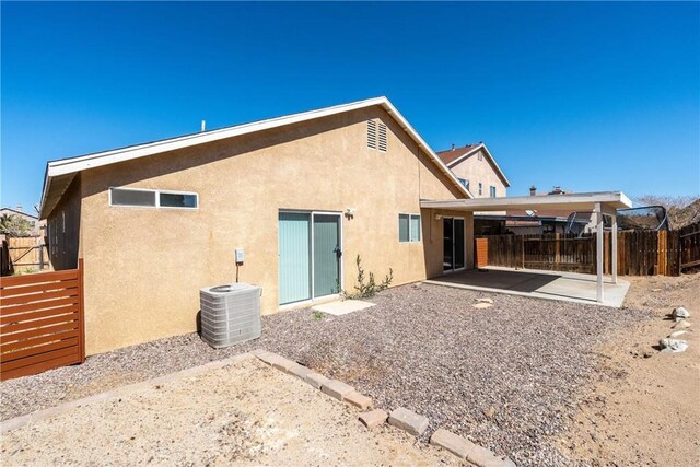 13625 Brynwood St, Victorville, CA 92392 - back of house featuring central air condition unit, stucco siding, and a patio area