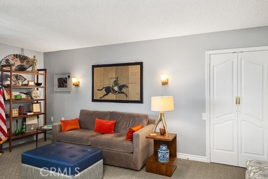 living room with carpet and baseboards