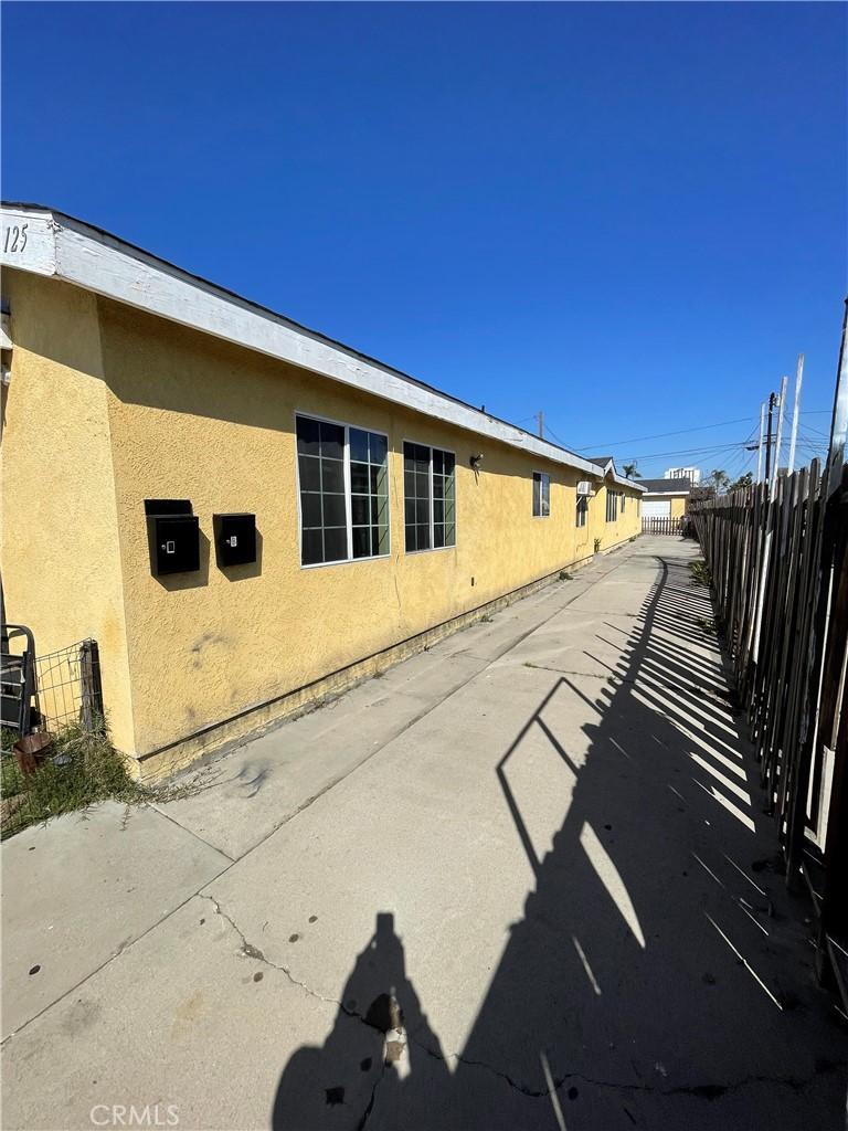 125 W Tichenor St, Compton, CA 90220 - view of side of property featuring stucco siding