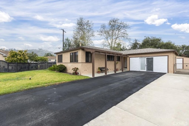single story home featuring a front lawn, driveway, stucco siding, and fence