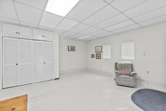 sitting room featuring baseboards and a paneled ceiling