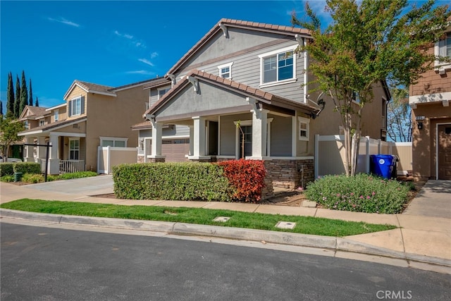 12241 Amaryllis, Yucaipa, CA 92399 - view of front of home with stone siding, a tile roof, driveway, and covered porch