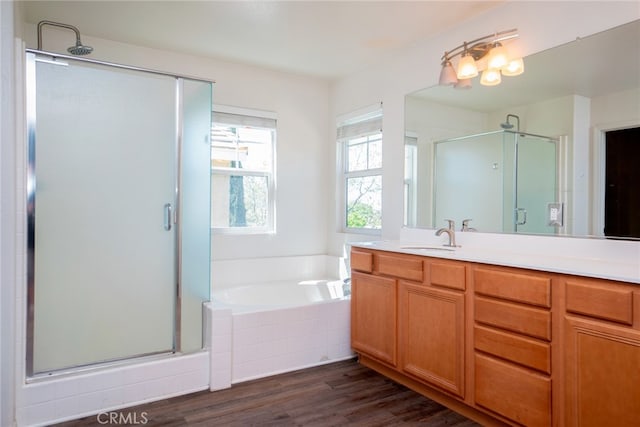 12241 Amaryllis, Yucaipa, CA 92399 - full bathroom featuring a stall shower, vanity, a garden tub, and wood finished floors