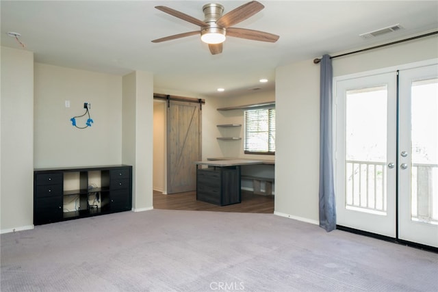 12241 Amaryllis, Yucaipa, CA 92399 - unfurnished living room with a barn door, carpet flooring, french doors, a ceiling fan, and baseboards