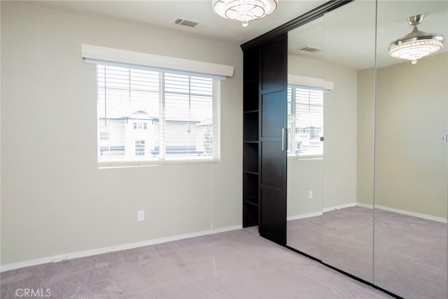12241 Amaryllis, Yucaipa, CA 92399 - unfurnished bedroom featuring carpet flooring, multiple windows, a closet, and baseboards