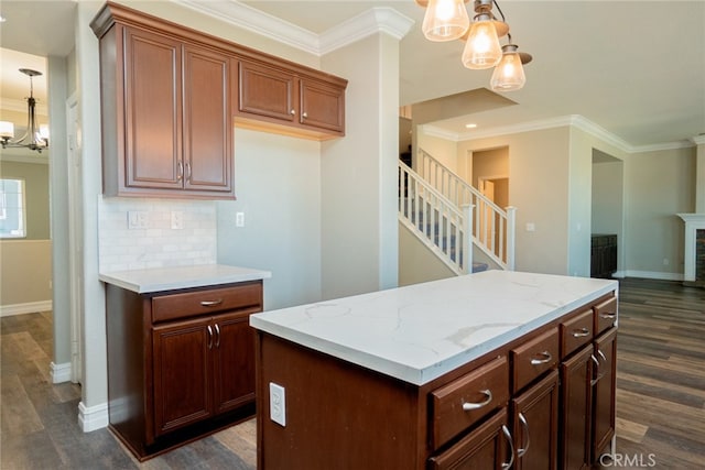 12241 Amaryllis, Yucaipa, CA 92399 - kitchen with a chandelier, crown molding, dark wood finished floors, baseboards, and decorative backsplash