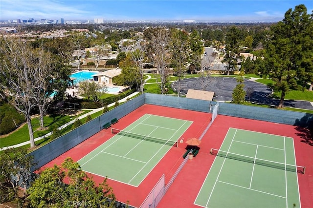 view of tennis court featuring fence