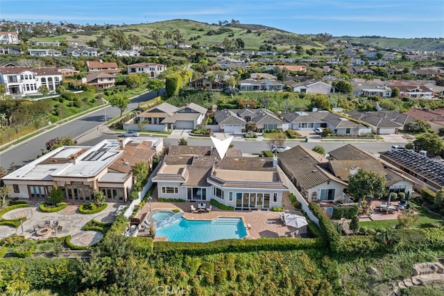 aerial view of property and surrounding area with nearby suburban area and a pool