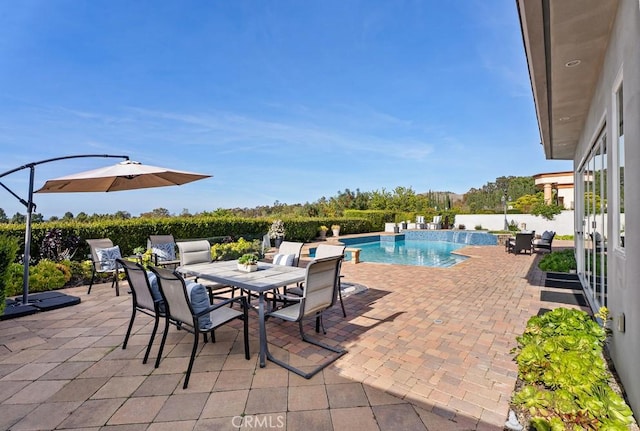 view of swimming pool featuring a patio area and outdoor dining space