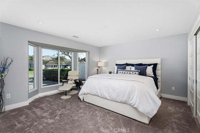 carpeted bedroom featuring baseboards and recessed lighting