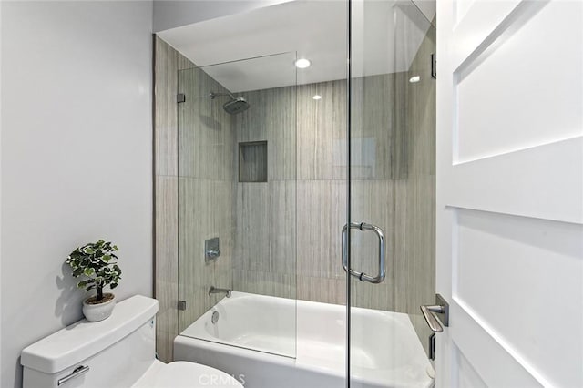 bathroom featuring toilet and enclosed tub / shower combo