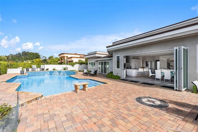 view of swimming pool featuring a patio area and fence