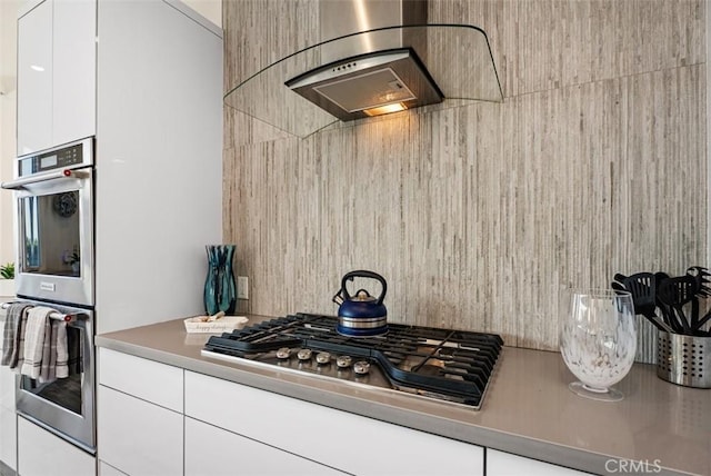kitchen featuring stainless steel appliances, modern cabinets, and white cabinets