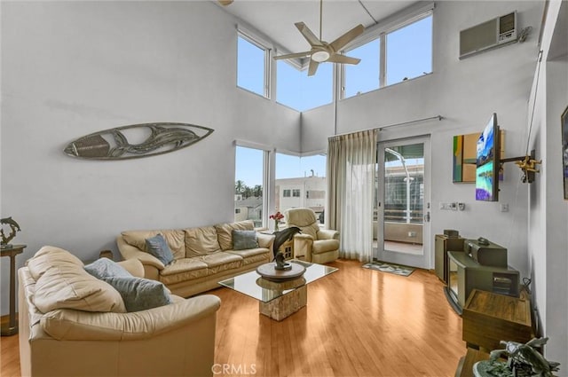 16745 Bayview Dr Unit B, Sunset Beach, CA 90742 - living area with ceiling fan, light wood finished floors, a high ceiling, and a wall mounted air conditioner