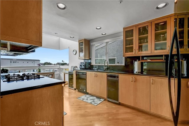 16745 Bayview Dr Unit B, Sunset Beach, CA 90742 - kitchen featuring black dishwasher, white gas stovetop, a sink, light wood-style floors, and glass insert cabinets