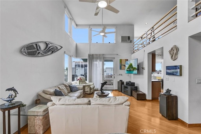 16745 Bayview Dr Unit B, Sunset Beach, CA 90742 - living area with ceiling fan, light wood finished floors, plenty of natural light, and a high ceiling