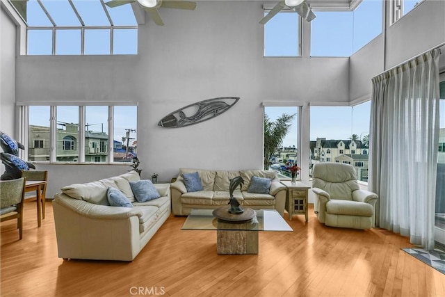 16745 Bayview Dr Unit B, Sunset Beach, CA 90742 - living room with ceiling fan, a towering ceiling, hardwood / wood-style floors, and plenty of natural light
