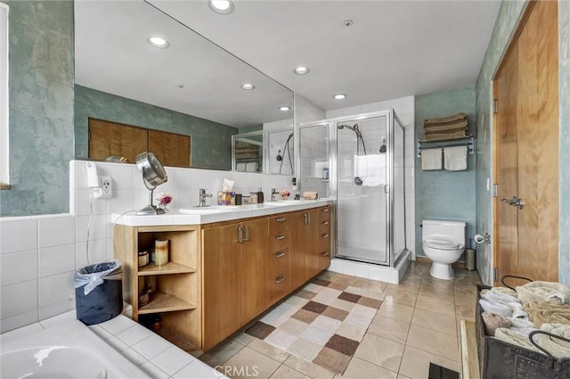 16745 Bayview Dr Unit B, Sunset Beach, CA 90742 - bathroom with tile walls, a stall shower, toilet, double vanity, and recessed lighting