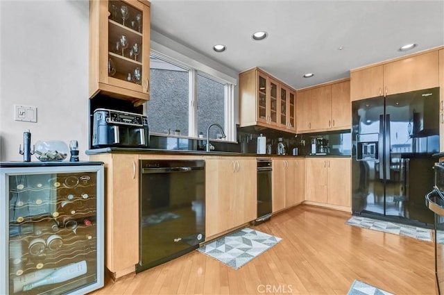 16745 Bayview Dr Unit B, Sunset Beach, CA 90742 - kitchen featuring black appliances, beverage cooler, light wood-style floors, dark countertops, and glass insert cabinets