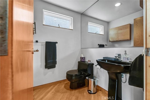 16745 Bayview Dr Unit B, Sunset Beach, CA 90742 - bathroom featuring toilet, wood finished floors, and baseboards
