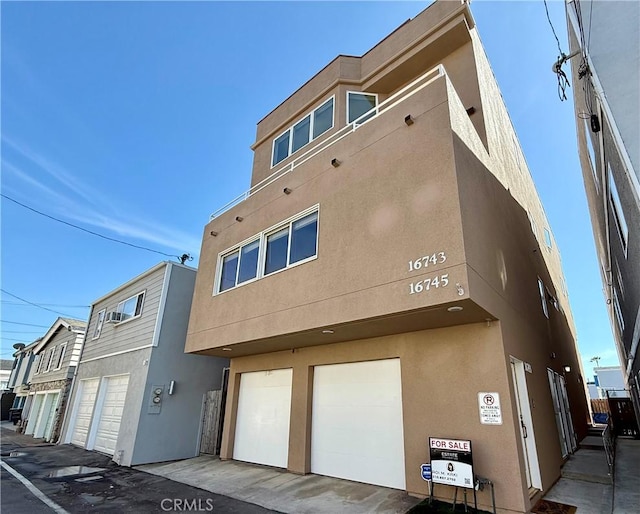 16745 Bayview Dr Unit B, Sunset Beach, CA 90742 - view of property featuring a garage