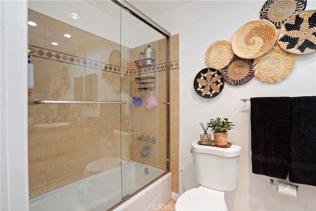 bathroom with toilet and enclosed tub / shower combo