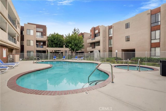 pool featuring fence and a patio area