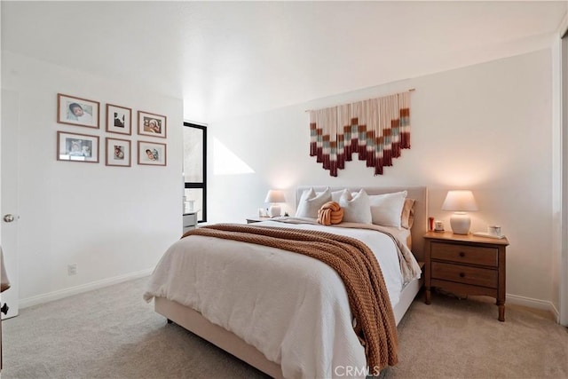 carpeted bedroom featuring baseboards