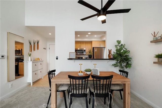 dining space with light colored carpet, baseboards, a ceiling fan, and recessed lighting