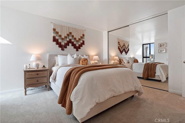 carpeted bedroom featuring baseboards