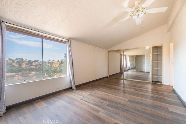 27062 Rd 400, Madera, CA 93636 - empty room featuring wood finished floors, a textured ceiling, lofted ceiling, baseboards, and ceiling fan
