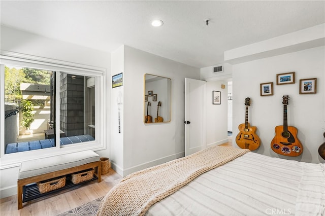 bedroom with recessed lighting, visible vents, baseboards, and wood finished floors