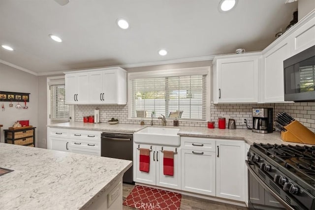 kitchen featuring black appliances, ornamental molding, a sink, and white cabinets