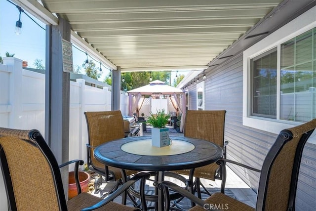 sunroom featuring outdoor dining area