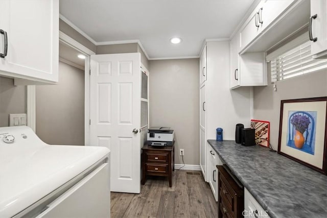 washroom with crown molding, recessed lighting, washer / clothes dryer, light wood-style flooring, and cabinet space